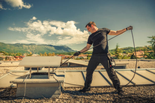 chimney sweeper cleaning a chimney on top of the roof chimney sweeper cleaning a chimney on top of the roof